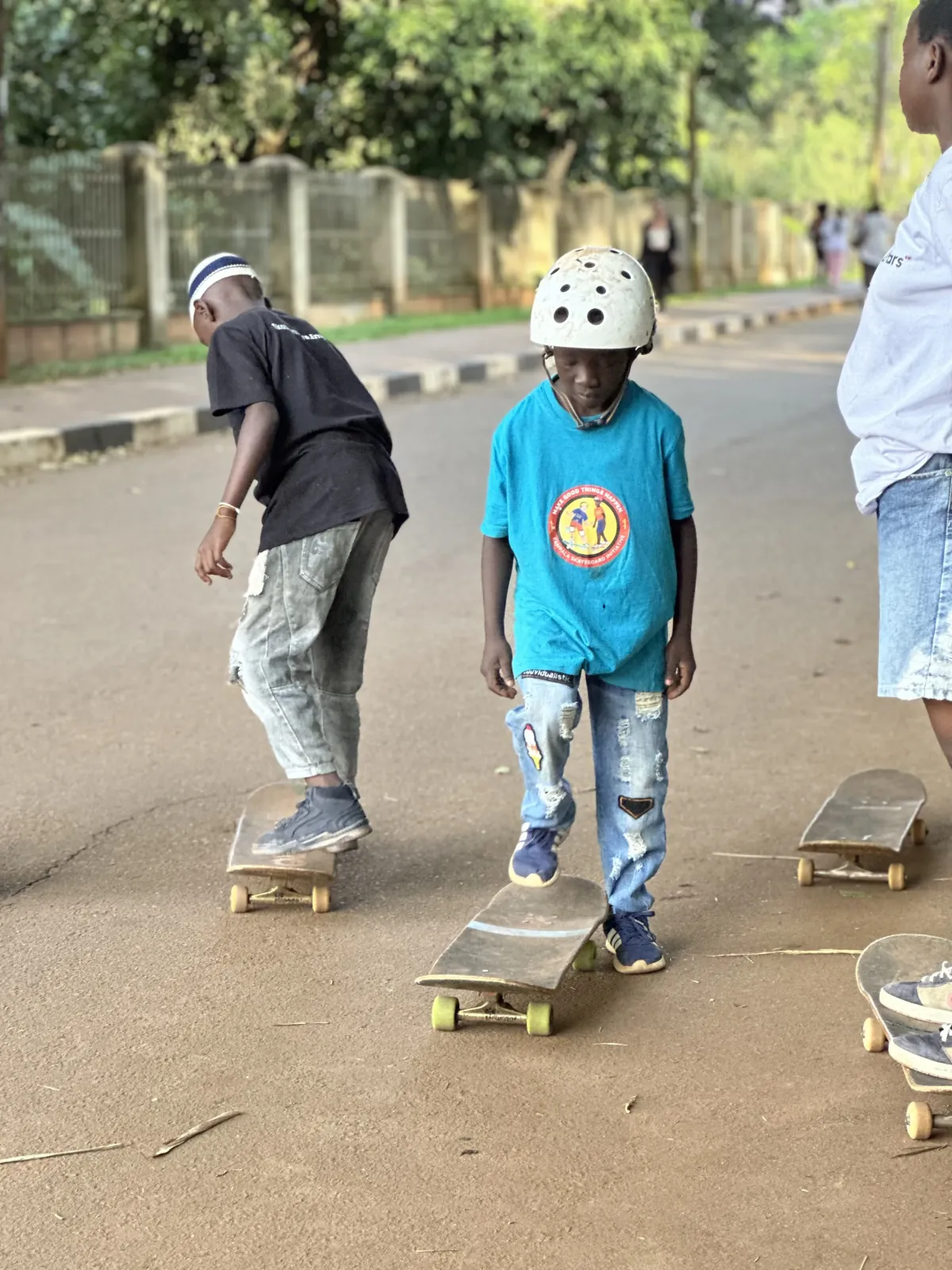 KSI children practicing skateboarding on the street