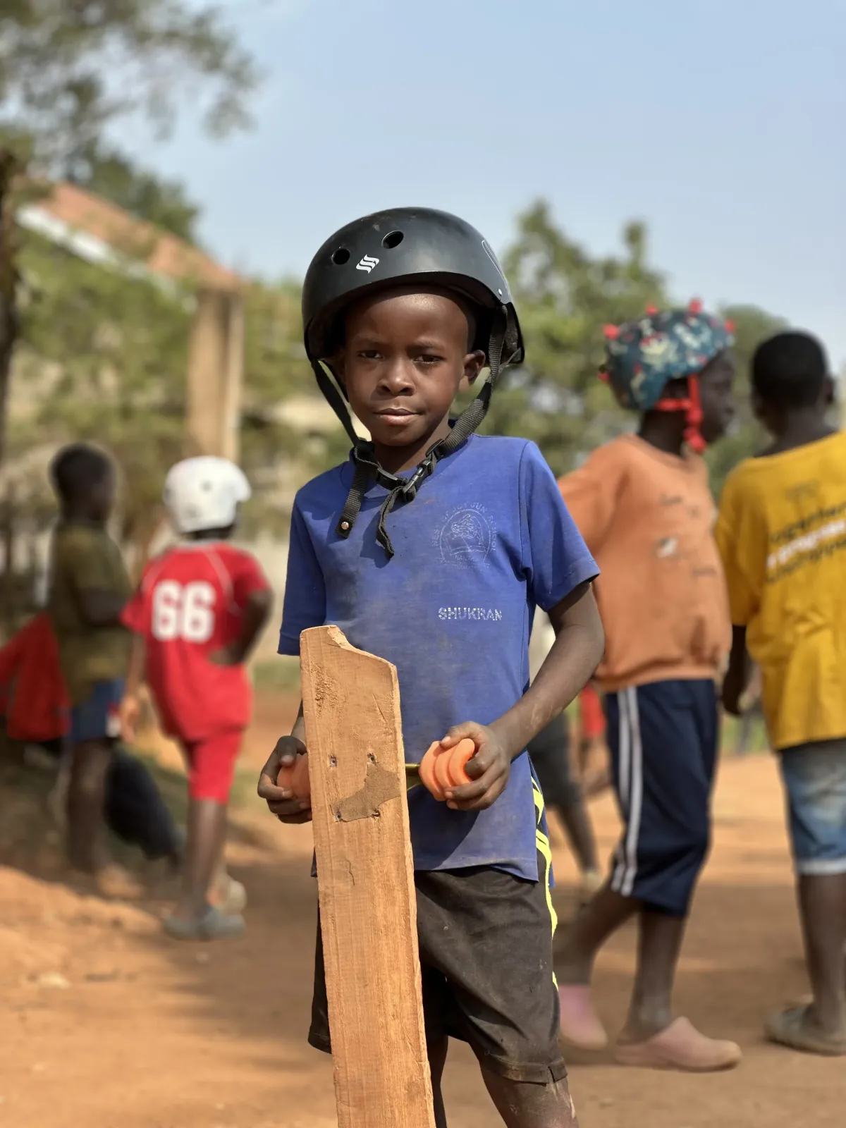 Young child with helmet holding a skateboard